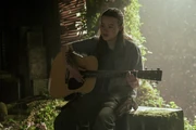 Ellie playing guitar for Dina.