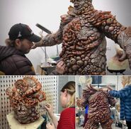 Artists working on the practical bloater suit.