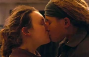 Ellie kissing Riley.