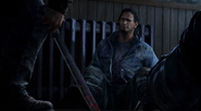 Joel picking up a machete (in the game that became a pipe)