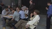 The boys eating pizza in the warehouse