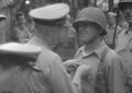 During a visit to Guadalcanal in 1942, Adm Chester Nimitz, CINCPAC, decorates Col Merritt 'Red Mike' Edson with the Navy Cross for heroism in action while in command of the 1st Raider Battalion in the assault on Tulagi from 7-9 August 1942. Still image from USMC motion picture film