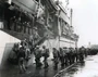 On the rainy afternoon of 2 January 1945 Marines of 3rd Battalion, 26th Marines board the USS Darke (APA-159) at Hilo Harbor on the big island of Hawaii. US Navy Photo