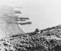 A lone Marine covers the left flank of a patrol as it works its way up the slopes of Mount Suribachi. It was from this vantage point on the enemy-held height that Japanese gunners and observers had a clear view of the landing beaches.