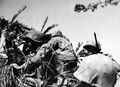 1945-Marines in combat on southern Okinawa. The First and Sixth Marine Divisions fought in this, the last campaign of the war. The island's rugged terrain posed an extreme challenge that required the utmost in courage and tactics. Still image from USMC motion picture film