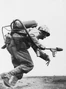 A Marine flamethrower operator moves forward to assault a Japanese pillbox on Motoyama Airfield. Department of Defense Photo (USMC) 111006.