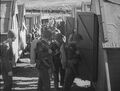 20 June 1942-At their new camp outside of Wellington, Marines of the 1st MarDiv find their bunks under the watchful eye of their platoon sergeant. The Marine standing in the door is a BAR man and his NCO carried a Reising submachine gun. The division only stayed in New Zealand for a very short time. Still image from USMC motion picture film