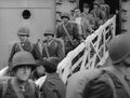 20 June 1942-Wellington Harbor, New Zealand. Troops of the 1st MarDiv debark from their transport after over a month at sea. Most of them wear the winter service uniform and they are still equipped with the M1903 rifle. Still image from USMC motion picture film