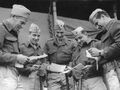 A posed shot of 1st MarDiv troops reading their mail, Melbourne, Australia, 1943. Australian War Memorial