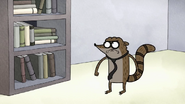 Rigby stares at the bookshelff