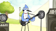 Mordecai wearing his Mordecai and the Rigbys t-shirt, with the sleeves ripped off, and a white sweatband in "Return of Mordecai and the Rigbys"