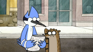 S2E25.012 Mordecai and Rigby looking at the newspaper