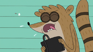 S7E36.019 Rigby Coughing Out a Dandelion Seed