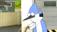 S6E06.169 Rigby Rubbing His Paycheck in Mordecai's Face