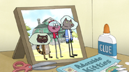 S7E07.076 Photo of Benson, Mordecai, and Rigby with Cat Heads