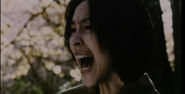 Etsuko screaming in fear after seeing Sadako in the forest.