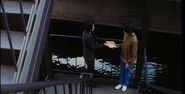Akiko giving Etsuko a recording tape of the ESP demonstration.
