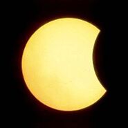 A partial eclipse can be seen, where the moon can be seen obscuring a portion of the Sun. This is not the same perspective seen around the entirety of the planet, for the umbra apparently more stretched out in this region of the world.