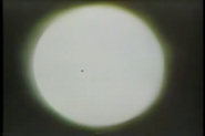 An artist's view of the Sun shows the spot (Mercury) to be visible. Copyright © 1991 Don Barrett