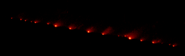 Image of the comet, torn in multiple pieces, about to collide with Jupiter.