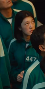 The female Player 447 looking at the piggy bank