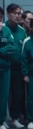 Player 443 watching Gi-hun wake up in the coffin.