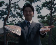 The Recruiter offering the homeless man a bread roll or a lottery ticket.