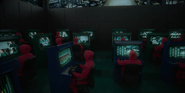 Player 443 (far left) being monitored by Squid Game staff