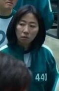 Female Player 440, waiting in line for food