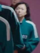 The other female Player 003, who is the same actress as Player 171 and Player 003's icon walking to take her photo