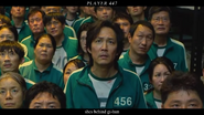 The female Player 447 behind Gi-hun just before Il-nam votes