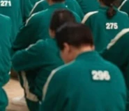 Player 296 sitting with his team in a BTS image.