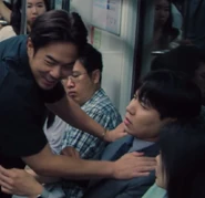 Player 080 before he joined the games having his bag searched by Mr Kim and Woo-seok.