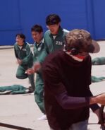 Another Player 236 with Player 454 running to the finish line in Behind the Scenes in Red Light Green Light