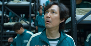 Player 239 walking behind Seong Gi-hun