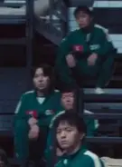 Player 080 watches as Gi-hun wake up.