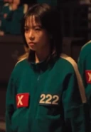 Jun-hee watching Gi-hun begging the guards to kill him.