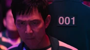 Gi-hun behind him is the hidden Player 001.