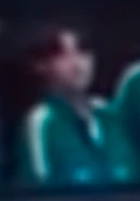 Player 024 watching the revolting players gather their guns.