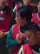 Player 260 looking at Kim Gi-min as he complaining the guards.