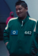 Player 442 looking at Gi-hun after the fourth vote.