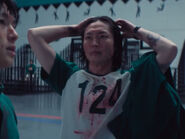 Nam-gyu noticing he lost his crucifix after the fourth game