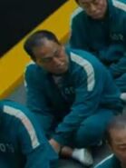 The male Player 401 sitting down in Tug of War