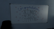 The whiteboard on the left.