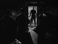 The Thing stands silhouetted in the doorway of the living quarters