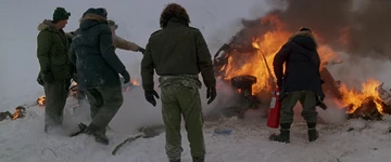 The crew examine the helicopter wreckage, The Thing (1982).