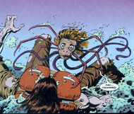 The Spider-Head form of the Jenny-Thing attacks MacReady.