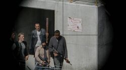 Sasha teniendo en la mira a Negan con su arma.