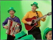 Jeff playing accordion and Greg playing red Takamine acoustic guitar