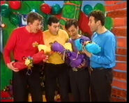 The Wiggles holding Wags' bones